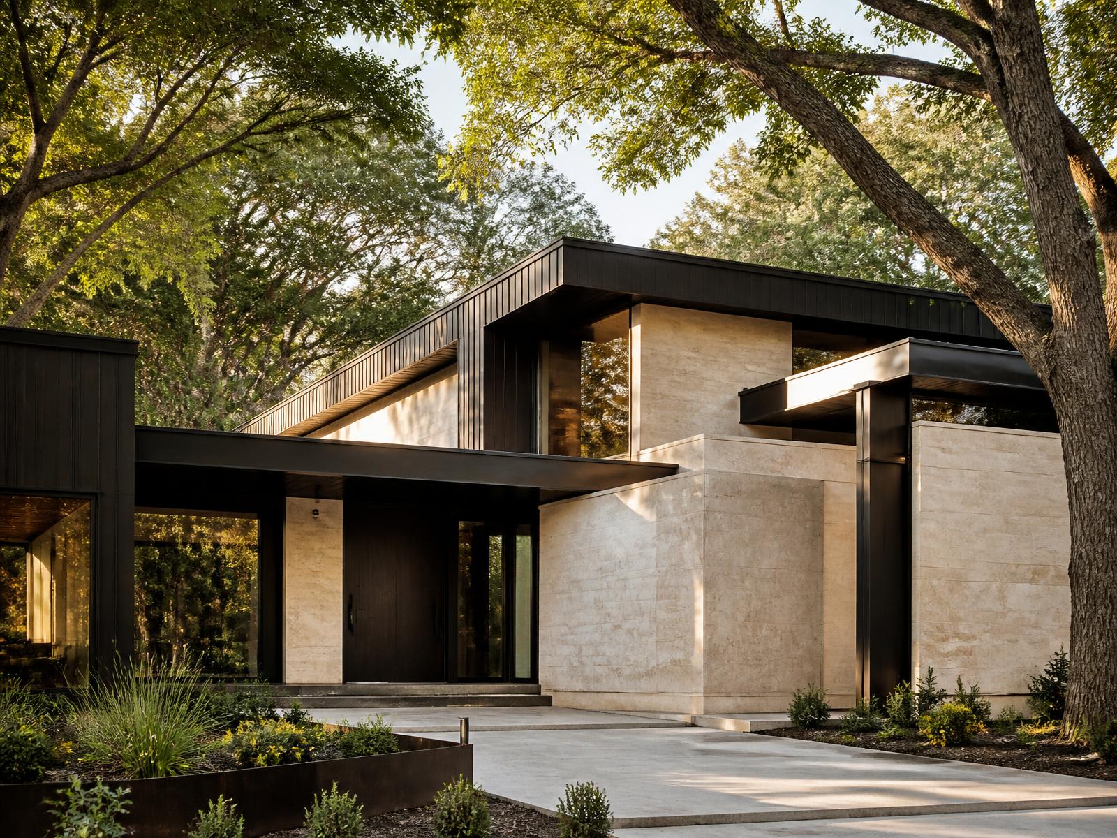 Contemporary limestone and black steel home beneath mature trees